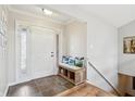 Inviting foyer with tiled flooring, a bench with decorative pillows, and a view of the staircase at 5325 Tracey Jo Rd, Greenwood, IN 46142