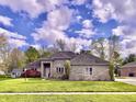 Attractive brick home with a well-manicured lawn and lovely landscaping at 5441 Red Hawk Ln, Greenwood, IN 46142