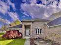 Close up of a brick facade with covered front door and attractive landscaping at 5441 Red Hawk Ln, Greenwood, IN 46142