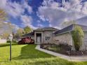 Beautifully landscaped front yard with lush lawn and stone walkway to the covered front door at 5441 Red Hawk Ln, Greenwood, IN 46142