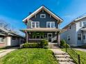 Inviting two-story home with a well-manicured lawn and classic architectural details at 5442 Hibben Ave, Indianapolis, IN 46219