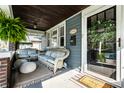 Relaxing front porch with comfortable wicker furniture and charming decor at 5442 Hibben Ave, Indianapolis, IN 46219