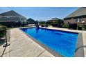 Inviting backyard pool area with slide, lounge chairs, and outdoor kitchen setup at 5802 Bentbrook Dr, Bargersville, IN 46106