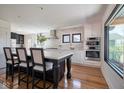 Open kitchen featuring a large island, stainless steel appliances, and hardwood floors at 6173 Rosslyn Ave, Indianapolis, IN 46220