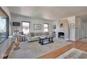 Bright living room featuring a decorative fireplace, large windows, and stylish decor at 6173 Rosslyn Ave, Indianapolis, IN 46220