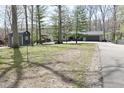 Home with a large front yard and a driveway leading to a garage, surrounded by mature trees at 7014 Eagle Dr, Nineveh, IN 46164