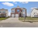Attractive two-story home with a brick facade, two-car garage, and well-kept lawn, complete with a mailbox at 7128 English Oak Dr, McCordsville, IN 46055