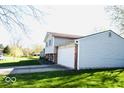 This house boasts a well-manicured lawn, and an attached garage at 7838 Burr Oak Ct, Indianapolis, IN 46217