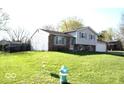 Charming home with a spacious front yard, mature trees, and a side-entry garage at 7838 Burr Oak Ct, Indianapolis, IN 46217