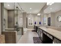 Modern bathroom featuring a glass-enclosed shower, double vanities, and stylish finishes at 7957 Beaumont Green West Dr, Indianapolis, IN 46250