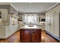 Spacious kitchen with white cabinets, a wooden island, and hardwood floors, ready for culinary adventures at 7957 Beaumont Green West Dr, Indianapolis, IN 46250
