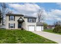 Attractive two-story home with a well-maintained lawn and a convenient two-car garage at 8231 N Chaucer Ct, Columbus, IN 47201