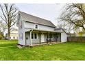 Charming two-story home featuring a covered porch, well-maintained lawn, and traditional architecture at 831 N 12Th St, Elwood, IN 46036