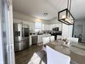 Modern kitchen featuring stainless steel appliances, white cabinets, and a stylish dining area at 8333 Sansa St, Indianapolis, IN 46113