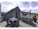 Open rooftop deck with modern outdoor furniture, dining space, and views of neighborhood at 8740 Morgan Dr, Fishers, IN 46038