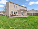The house has a large backyard with chairs and grass, and could be used for many outdoor activities at 8813 Browns Valley Ln, Indianapolis, IN 46113