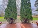 View from deck overlooking backyard with mature trees and a wooden fence surrounding the property at 9362 Helmsdale Dr, Indianapolis, IN 46256