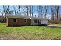 Well-maintained brick home with a green lawn, a charming porch swing, and a two-car garage at 9882 Woodbriar Ln, Carmel, IN 46280