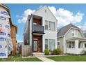 Modern two-story home featuring vinyl siding, balcony and charming front yard landscaping at 1015 Villa Ave, Indianapolis, IN 46203