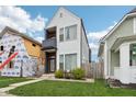 Modern two-story home featuring vinyl siding, balcony, landscaped front yard and walkway at 1015 Villa Ave, Indianapolis, IN 46203