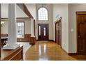 Elegant foyer with hardwood floors, high ceilings, large windows, and decorative columns at 10814 Tallow Wood Ln, Indianapolis, IN 46236