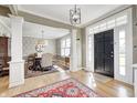 Welcoming foyer showcasing hardwood floors, columns, and a glimpse into the dining room at 10846 Hamilton Pass, Fishers, IN 46037