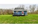 A spacious backyard featuring a new black deck and lush greenery at 10880 N 23Rd St, Elwood, IN 46036