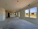 Open-concept living space featuring large windows and a glimpse of the kitchen at 1268 Fleming Dr, Greenfield, IN 46140