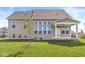 Spacious backyard with a covered porch, ideal for outdoor entertaining and relaxation at 12894 Corydon Dr, Fishers, IN 46037