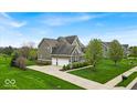 Traditional two-story home with three-car garage and well-manicured lawn at 1533 Windswept, Brownsburg, IN 46112