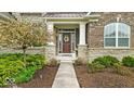 Charming front entrance with brick and stone accents, leading to a cozy home at 1533 Windswept, Brownsburg, IN 46112