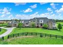 Expansive stone home features a long driveway and lush green lawn at 1581 S 825 E, Zionsville, IN 46077