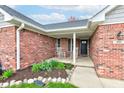 Charming front porch with rocking chairs and well-maintained landscaping at brick home at 1707 Lafayette Ave, Lebanon, IN 46052