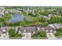 Expansive aerial view shows home's proximity to serene pond and lush green neighborhood at 17777 Crown Pointe Ct, Noblesville, IN 46062