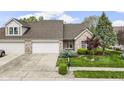 Beautiful brick home with attached garage and a well-maintained lawn and landscaping at 17777 Crown Pointe Ct, Noblesville, IN 46062