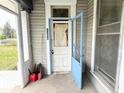 View of a front porch showing the address of the house and an open door at 2208 Avondale Pl, Indianapolis, IN 46218