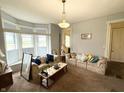 Cozy living room with large windows and comfortable couches perfect for relaxing at 2208 Avondale Pl, Indianapolis, IN 46218