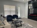 Living room with a black fireplace, two chairs, and a sofa on an area rug at 2232 Central Ave, Indianapolis, IN 46205