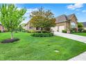 Spacious home with a well-manicured lawn, mature trees, and a convenient three-car garage at 2507 Silver Oaks Dr, Carmel, IN 46032