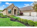 Beautiful home featuring lush landscaping, a three-car garage, and a well-kept lawn at 2507 Silver Oaks Dr, Carmel, IN 46032