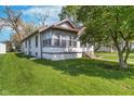 Inviting home exterior surrounded by green lawn, providing a serene and peaceful living environment at 2735 S Taft Ave, Indianapolis, IN 46241