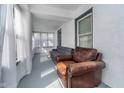 Cozy sunroom featuring comfortable seating with couch and armchair, creating a relaxing retreat at 2735 S Taft Ave, Indianapolis, IN 46241