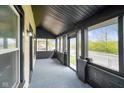Spacious screened porch featuring painted beams and a view of the surrounding neighborhood at 2926 Indianapolis Ave, Indianapolis, IN 46208