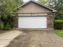 Attached garage with a white door provides secure parking and storage at 3202 Acacia Dr, Indianapolis, IN 46214