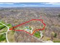 An aerial view shows the expansive property surrounded by lush forest, marked by a red outline at 3504 Morgan Oaks Cir, Martinsville, IN 46151