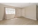 Bright living room features modern flooring, neutral walls, and a large window with natural light at 3550 Winings Ave, Indianapolis, IN 46221