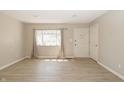 Bright living room features modern flooring, neutral walls, and a large window with natural light at 3550 Winings Ave, Indianapolis, IN 46221