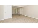 Spacious room with modern flooring, neutral paint and multiple entryways to other parts of the home at 3550 Winings Ave, Indianapolis, IN 46221