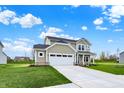 Two-story home with a manicured lawn and a two-car garage and inviting covered front porch at 4087 Railhead Ave, Westfield, IN 46074