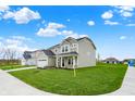 Newly built two-story house with fresh lawn, a two-car garage and inviting covered front porch at 4087 Railhead Ave, Westfield, IN 46074